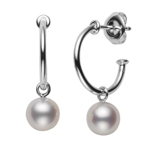 A pair of white gold drop earrings feature two elegant pearls