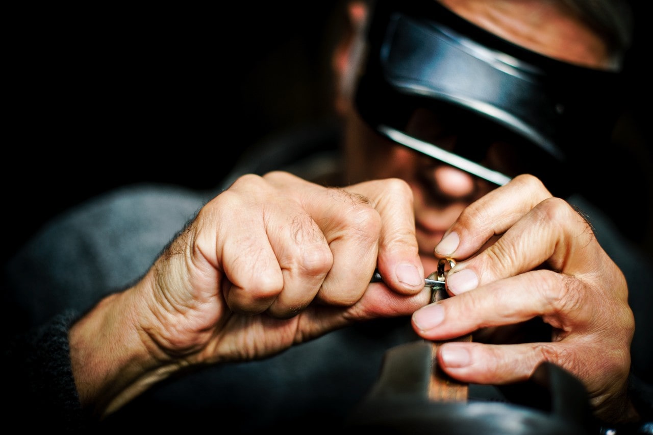 A close-up of a jeweller working on a ring. A close-up of a jeweller working on a ring.