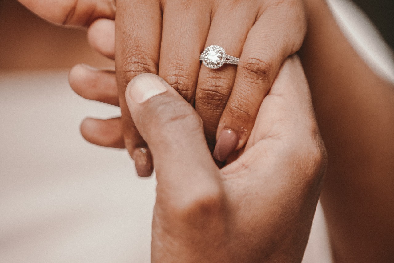 looking at halo engagement ring on hand